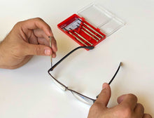 144 Piece Household Tool Kit with 4.8V Cordless Screwdriver - DT8422 precision screwdriver shown in use on eye glasses