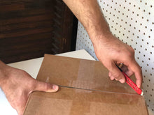 Apollo Tools 144 Piece Household Tool Kit with 4.8V Cordless Screwdriver - DT8422 utility knife shown in use cutting a cardboard box open