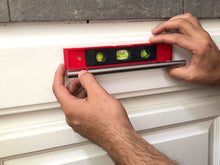 Apollo Tools 144 Piece Household Tool Kit with 4.8V Cordless Screwdriver - DT8422 torpedo level shown in use on a  horizontal drawer pull