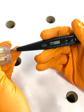 Apollo Tools 53 Piece Household Tool Kit - DT9408 shows voltage tester in use with hands wearing rubber gloves