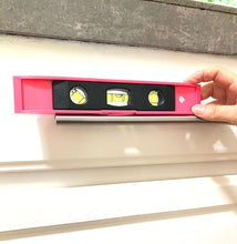 71 Piece Household Tool Kit Pink - DT0204P shows lifestyle image of a hand holding a pink level over a drawer