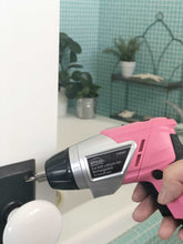 3.6 Volt Lithium-Ion Rechargeable Screwdriver with 45 Piece Accessory Set - Pink DT4944P shown in use to tighten door knob