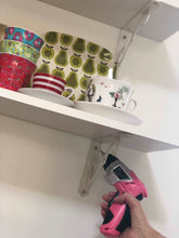 3.6 Volt Lithium-Ion Rechargeable Screwdriver with 45 Piece Accessory Set - Pink DT4944P shown in use tightening  shelf bracket