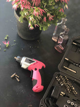 3.6 Volt Lithium-Ion Rechargeable Screwdriver with 45 Piece Accessory Set - Pink DT4944P shown on black table with a few bits and a portion of the case and bits