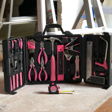 Apollo Tools 71 Piece Household Tool Kit Pink -model  DT0204P lifestyle image shows product in front of construction and ladder