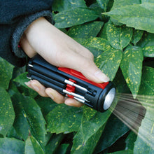 Apollo Tools Flashlight Mr. 7-Hands - DT1719 shown flashing its light in a garden setting