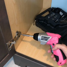3.6 Volt Lithium-Ion Rechargeable Screwdriver with 45 Piece Accessory Set - Pink DT4944P shown in use to tighten cabinet hinge.