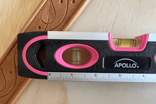 pink 9-inch torpedo-shaped spirit level with donation to breast cancer