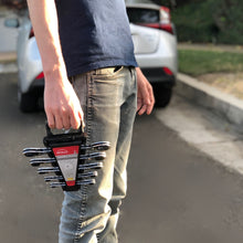 Apollo Tools 5 Piece SAE Ratcheting Wrench Set - DT1212 lifestyle image shows man holding wrench set with blurred car in background