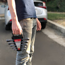 Apollo Tools 5 Ratcheting Wrenches - Metric - DT1213 shows man carrying the wrench set with blurred car in background