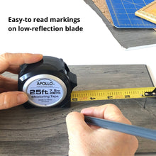 APOLLO TOOLS 25ft. Tape Measure - Black - DT5002 sows product in use and the sentence: easy to read markings on low reflection blade