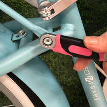 APOLLO TOOLS 2 Adjustable Wrenches - Pink - DT5007P lifestyle image shows box end of wrench in use on bicycle