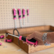 Apollo Tools 8 Pink Essential Screwdriver Set DT5018P shows woman's hand holding screwdriver with other screwdriver on peg board in background