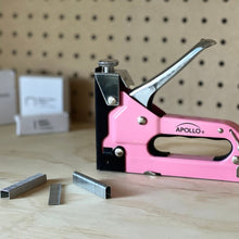 Pink Stapler with Power Adjustment Knob and 3000 Staples assortment-- DT5020P shown against peg board background 