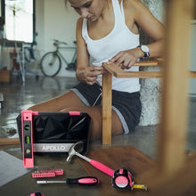 APOLLO TOOLS 39 Piece General Pink Tool Set in Storage Case with upgraded Tool Selection DT9711P shows lifestyle image of woman building furntiture and case and tools in the foreground