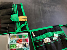 green and black bucket organizer shown flat with hobbies accessories for jewelry making